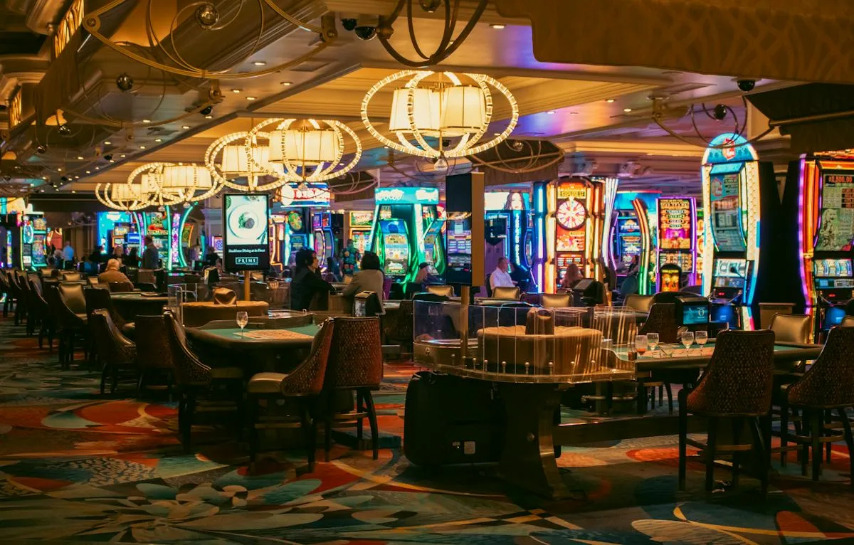 Illuminated casino gaming floor with rows of slot machines